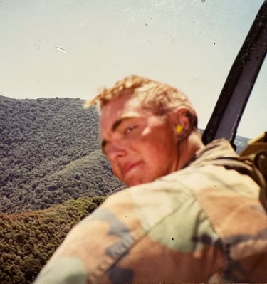 Marine Raider hanging out of a Huey