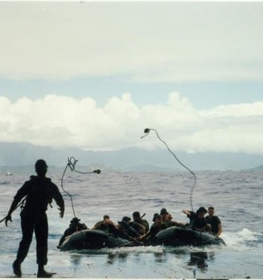 Raiders throwing a monkey's fist to recover on ship