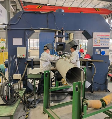 PMI Piping staff are working on welded pipes machines
