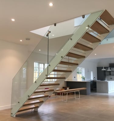 a beautiful staircase casement with a glass railing