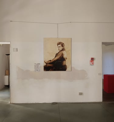 A sepia-toned portrait painting of Antonin Artaud a white gallery wall in a minimalist art studio.