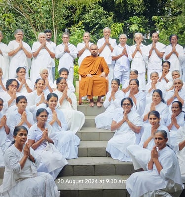 a group of people sitting on steps with their hands up