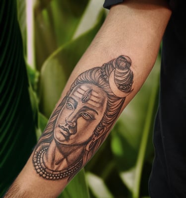 a man with a shiva tattoo on his arm