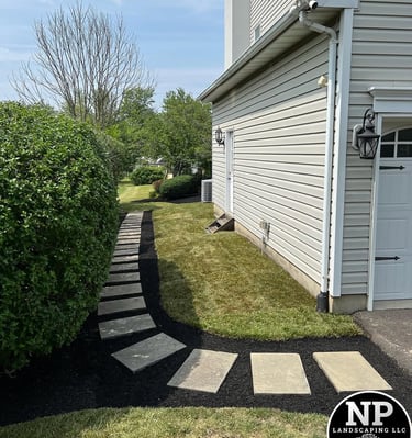 excellent landscaping and hardscaping of grass, stones and trees by NP Landscaping