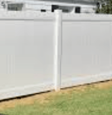 a white fenced in fenced in area with grass