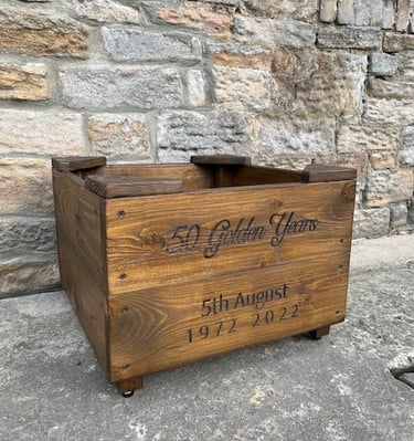 a wooden planter with personalised engraving on the front