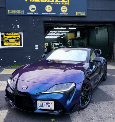 Custom purple and blue color shift car wrap on a Toyota Supra parked at Habazzi Auto Styling shop.