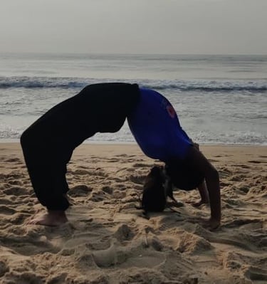a person doing a handstand on a beach