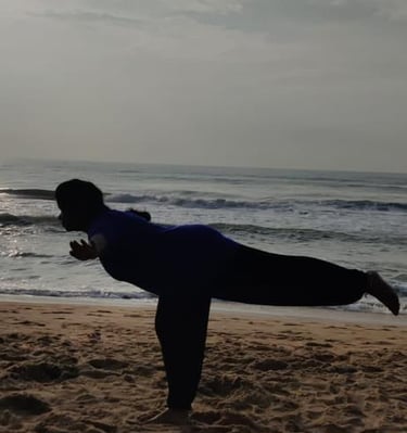 a person doing yoga on a beach