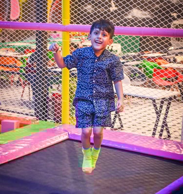 a young boy jumping on a trampoline trampoline trampoline tram