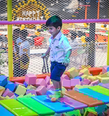a young boy playing with blocks on a playground