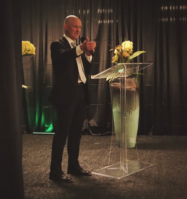 Man speaking at podium for event