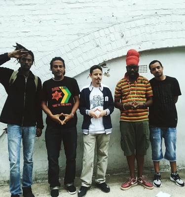 a group of men standing in front of a brick wall