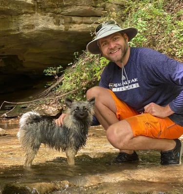 Tanner Morrill man with pomeranian keeshond mix wet dog