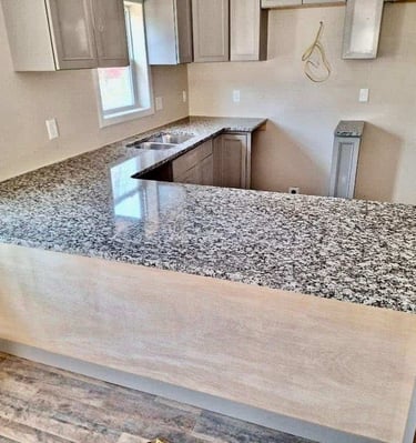 "Light gray granite with natural veining on display