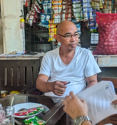 "A consultant explaining an interview questionnaire to a common man"