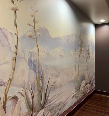 Wide angle view on a softly coloured desert dawn mural with direct lighting to illuminate mural.
