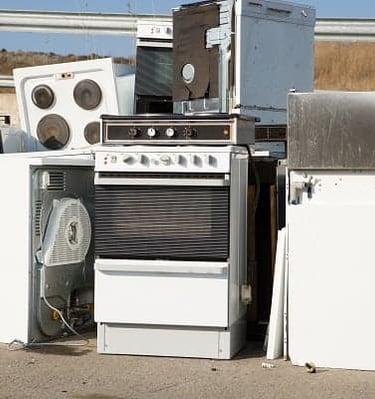 old appliance piled at recycling center