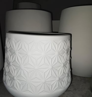 a white vase with a white vase on the ground