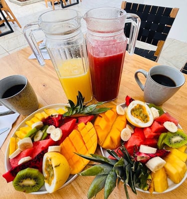 a plate of fruit and juice on a table