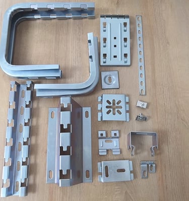 a variety of metal parts fittings of wire mesh cable tray