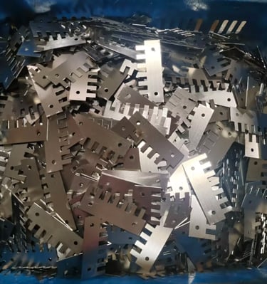 Precision laser cutting metal components and industrial steel parts piled