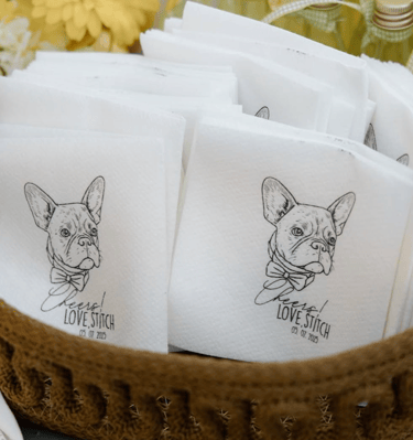 Custom wedding napkins featuring a French Bulldog illustration in a wicker basket.