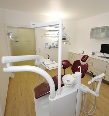 a dental room with a chair and a chair