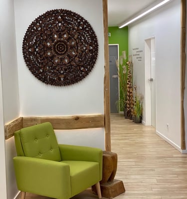 a green chair in a room with a wooden floor