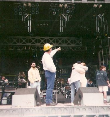 a man in a yellow hat and a yellow hat on stage