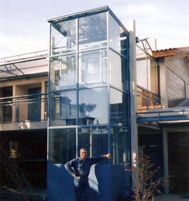 a man standing in front of a glass building