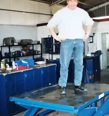 a man in a yellow helmet and a yellow helmet on a blue table