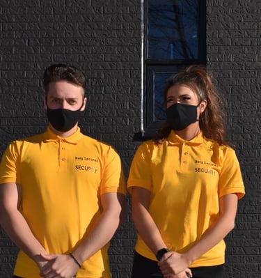 Two Security Guard Standing beside a building