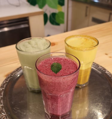 three glasses of smoothie with a mint green tea and a mint green tea