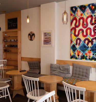 a restaurant with a large painting on the wall