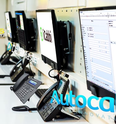 Modern dispatch workstations running iCabbi and DataMaster systems for taxi services.