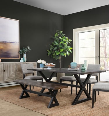 a dining room table with a bench and chairs