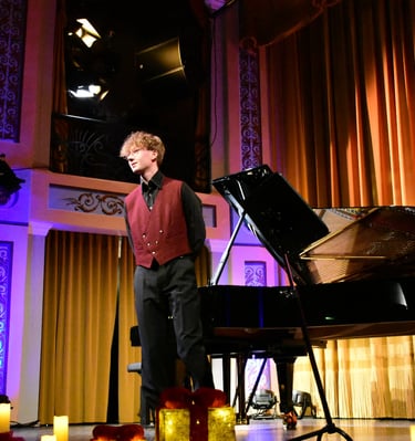 a man in a red shirt and tie dye on a stage