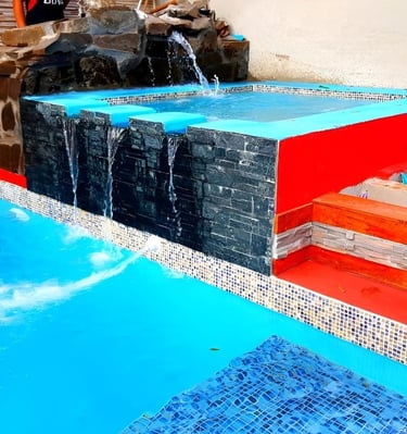 a pool with a waterfall and a waterfall