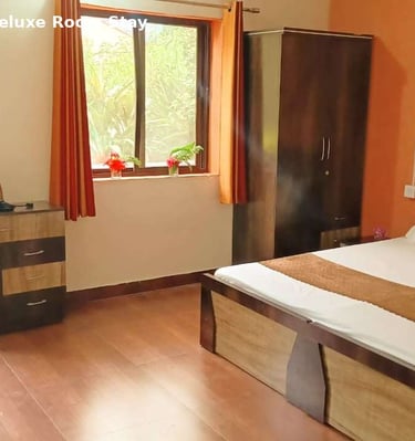 Deluxe room at Jungle Lore Resort with comfortable bed and modern interior