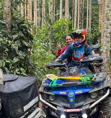 a man and woman riding on a four wheeler atv