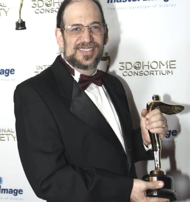 Ken Schafer Receiving Lumiere Statuette