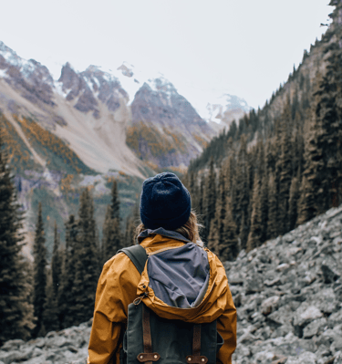 a person standing in front of a mountain