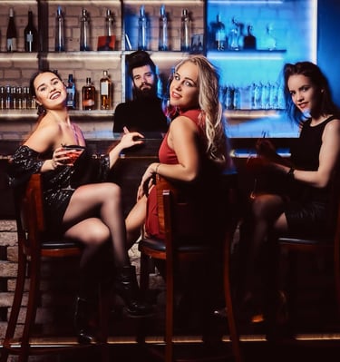 Group of friends enjoying cocktails at a stylish Las Vegas bar, creating a fun and vibrant nightlife atmosphere.