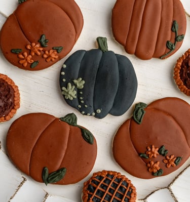 warm but dark themed fall cookies. pumpkins and flowers with rich dark colors