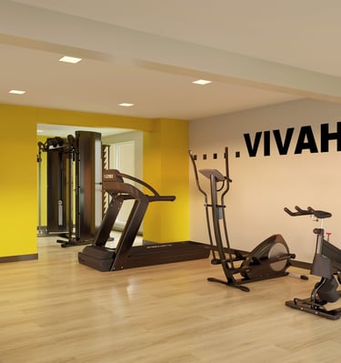 a gym room with a variety of exercise equipment