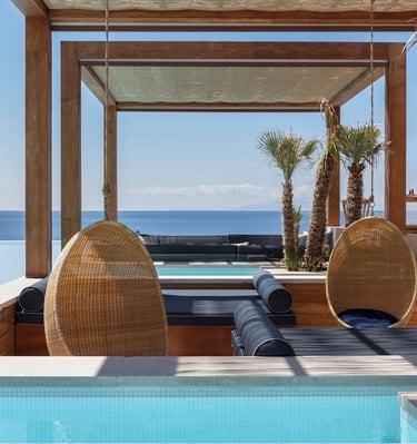 a lounge area with a lounge chair and a pool