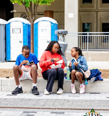 Children enjoying street food at the Afro Fiesta Festival outdoors.