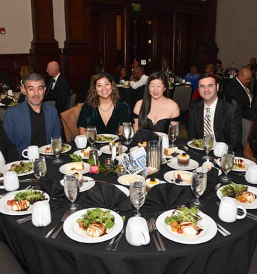 a group of people sitting around a table with plates of food for GFW MLK Jr. Community Event