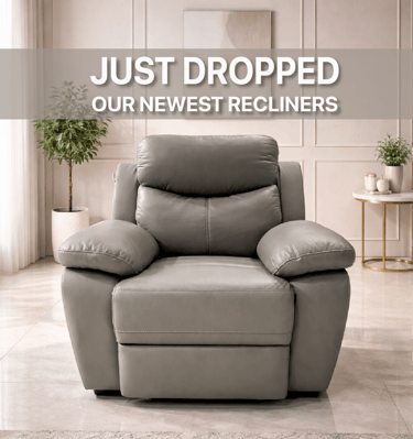 Modern grey leather recliner armchair in a bright living room with neutral decor.